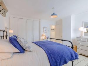 a white bedroom with a bed with blue pillows at 3 Bed in Whitstable WCC20 in Whitstable