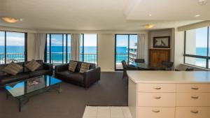 a living room filled with furniture and a large window at Carrington Court in Gold Coast