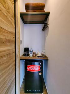 a coca cola refrigerator in a room with a counter at Habitacion Deluxe 2 con Jacuzzi a 20 mt del parque in Salento