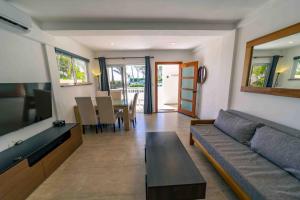 a living room with a couch and a table at WOW location Kite Beach Oceanfront 2 Bedroom Patio and Pool in Cabarete
