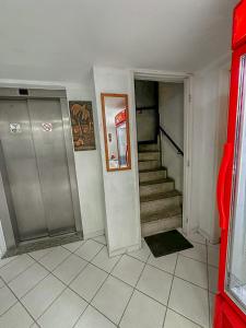 a hallway with a stairway with a pepsi machine at Hotel América Praia in Recife