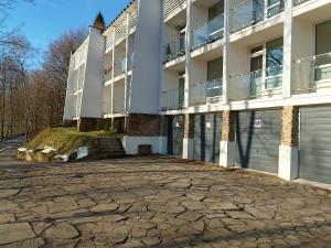 an apartment building with a stone driveway in front of it at Apartament Alias in Ustroń