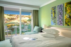 a bedroom with a bed and a large window at Hotel Kimen - Annex in Cres