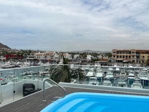 a balcony with a swimming pool and a marina at Great spot @ Marina, all Cabo's lifestyle on hand in Cabo San Lucas