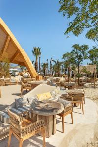 a patio with a couch and tables and chairs at Cullinan Belek in Belek