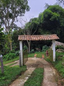 una entrada a un jardín con una puerta en Cabaña Caprichito, en Piedecuesta