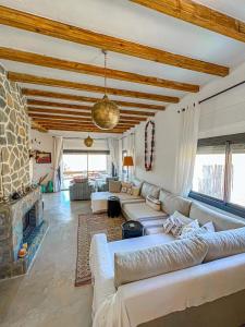 a living room with a couch and a fireplace at DMN - Dar Mama Noufissa 
