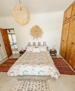 a bedroom with a large bed in a room at DMN - Dar Mama Noufissa 