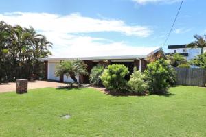 a house with a lawn in front of it at 12 Wilfred Street in Bargara
