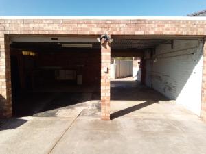 a brick garage with two entrances to a building at Homestay upon Kenwick Station in Perth