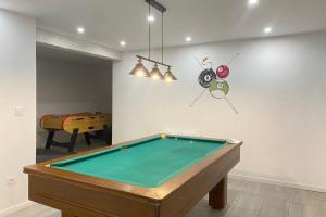 a pool table in a room with a ping pong ball at Lovely duplex with cinema room in Le Dévoluy