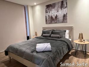 a bedroom with a large bed with a towel on it at Sumak Suite in Cuenca