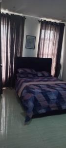 a bedroom with a bed with a quilt on it at Humsidcy Hub in Lagos
