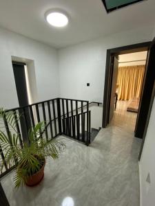 a room with a staircase and a potted plant at Humsidcy Hub in Lagos