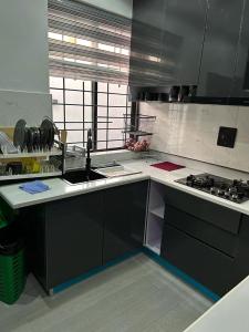 a kitchen with a sink and a stove at Humsidcy Hub in Lagos