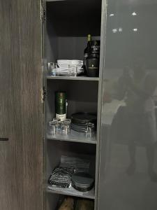 a cupboard with plates and dishes in it at Humsidcy Hub in Lagos