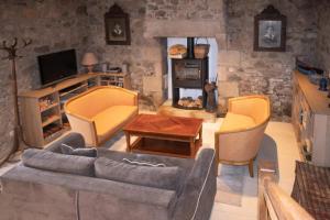 a living room with a couch and chairs and a tv at Résidence Ty Gouermel-plougrescant - Maisons & Villas pour 5 Personnes 854 in Lannion