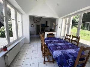 a dining room with a table and chairs and windows at Résidence -pleneuf Val Andre - Maisons & Villas 694 in Pléneuf-Val-André