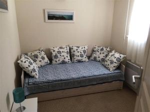- un canapé avec des oreillers dans l'établissement Résidence Les Bains - Charmant T3 à deux pas de la plage du Val André. MAE-6644, à Pléneuf-Val-André