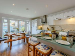 a kitchen with a table and chairs and a counter top at 3 Bed in Camber 87987 in Camber