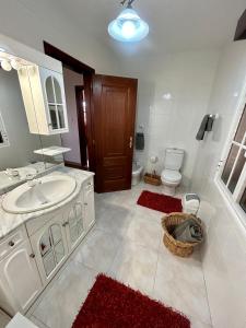 a bathroom with a sink and a toilet at Casa Carneirinho by Olá Madeira in Paul do Mar +67 photos