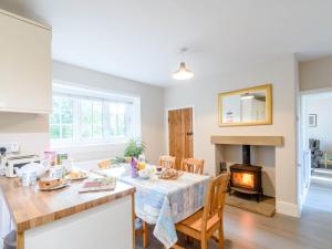 a kitchen and dining room with a table and a fireplace at 3 Bed in Kiplin 79275 in Great Langton