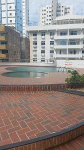 a pool in a courtyard in front of some buildings at Flat de dois quartos Number One in São Luís