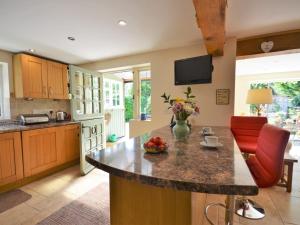 a kitchen with a island with a bowl of fruit on it at 2 Bed in Crickhowell 76431 in Llangenny