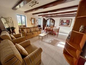 a living room with couches and a dining room at Casa Carneirinho by Olá Madeira in Paul do Mar