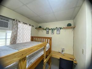 a bedroom with a wooden bed and a desk at Cozy & comfy house in La Chorrera