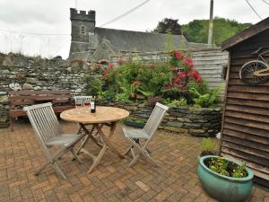 a patio with a table and chairs and a garden at 2 Bed in Satterthwaite and Grizedale LLH56 in Grizedale
