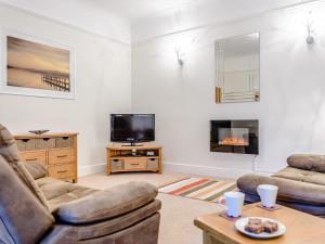 a living room with two couches and a tv at 2 Bed in Newton-by-the-Sea 80482 in Newton by the Sea