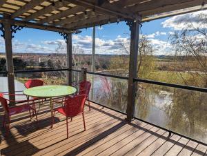 a patio with a table and chairs on a deck at Beautiful River View Apt in Wine Country in Canning