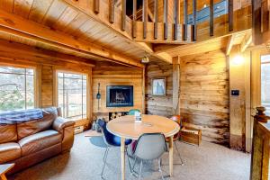a living room with a table and a couch at Oceanside Cabin in Neskowin