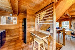 a wooden cabin with a table and a refrigerator at Oceanside Cabin in Neskowin +16 photos