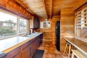 a kitchen with a sink and a refrigerator at Oceanside Cabin in Neskowin
