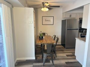 a kitchen with a table with chairs and a refrigerator at Gorgeous Remodeled Classy Family Apartment in Granite City