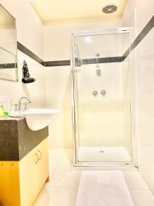 a bathroom with a shower and a sink at Townhouse in Mill Park +10 photos