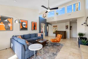 a living room with a blue couch and chairs at The Palms- Pool Jacuzzi and Pet Friendly in Palm Springs