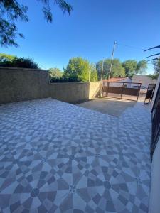 un patio con suelo de baldosa frente a una valla en kairos, en La Falda
