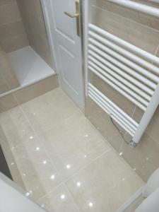 a bathroom with a white door and a tile floor at Best Experience Tours Centre in Tours