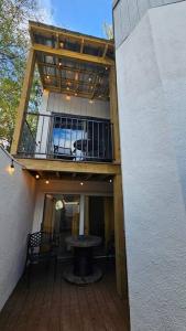 a building with a balcony with a table on a deck at Fully Furnished Vicksburg Home Sleeps 10 in Vicksburg