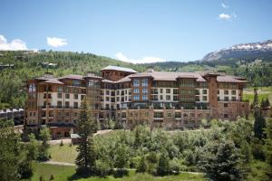 a large building in the middle of a mountain at Viceroy Snowmass in Snowmass Village