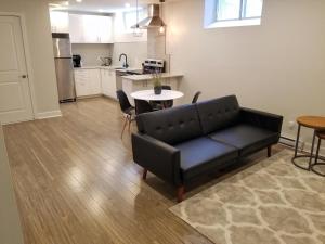 a living room with a couch and a table and a kitchen at Modern and spacious 2 bedroom in Montreal in Montreal