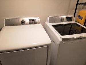 a white stove top oven next to a dishwasher at Modern and spacious 2 bedroom in Montreal in Montreal