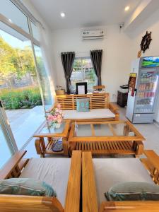 a room with several tables and a refrigerator at Amy Motel Xuyên Mộc in Xuyên Mộc