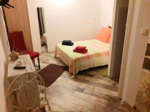 a small bedroom with a bed and a table at Apartments with parking space Bunica, Senj - 22142 in Senj
