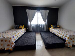 Una cama o camas en una habitación de Casa Quinta Aramis
