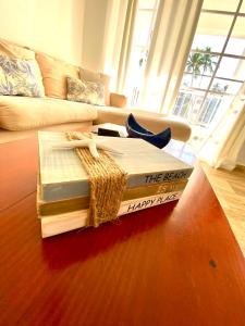 a stack of books sitting on a table in a living room at Beach and pool life in Punta Cana