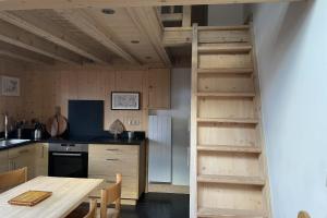 a kitchen with a loft bed in a kitchen with a table at Lovely family nest in Courchevel in Courchevel